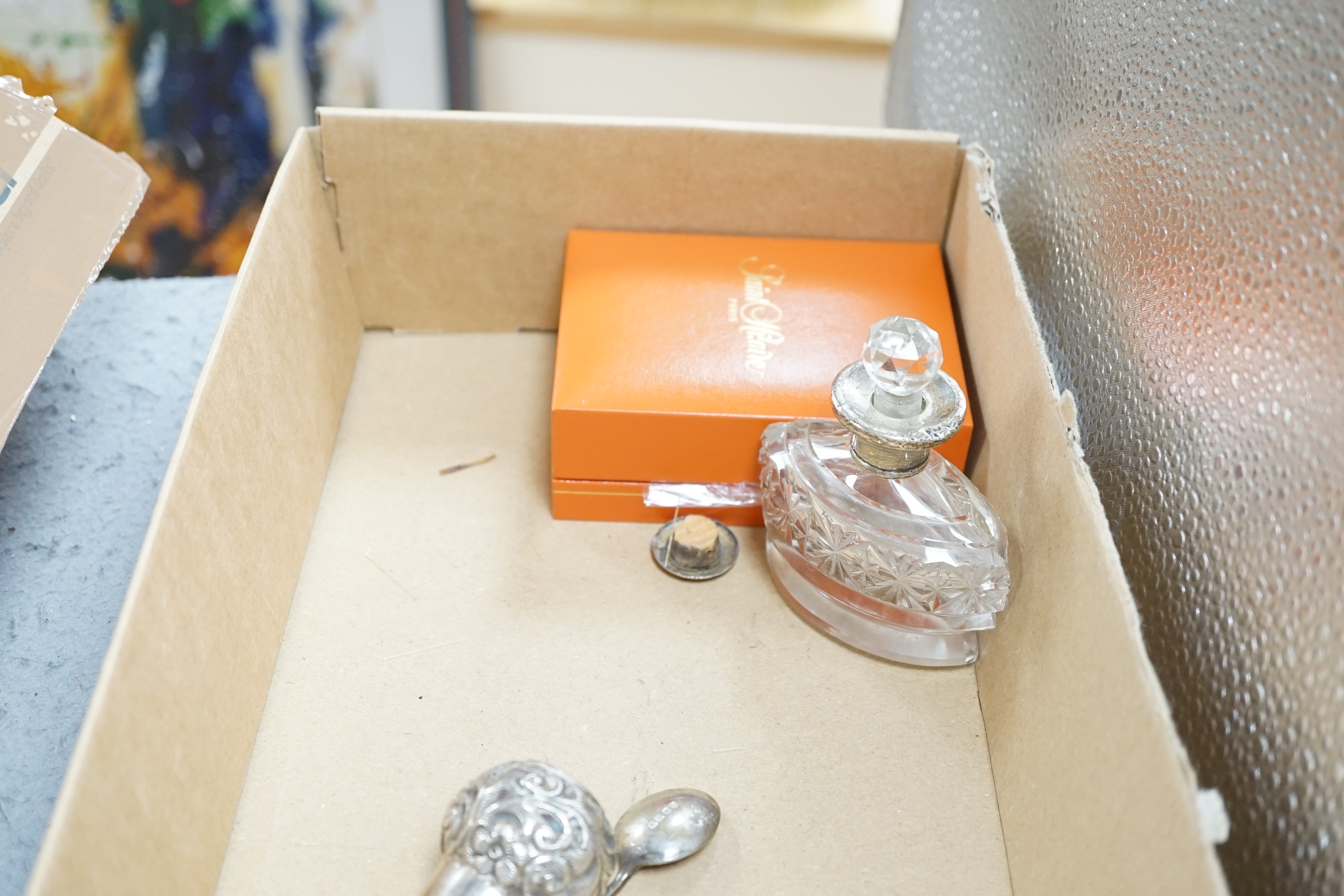 Seven assorted silver mounted glass scent bottles or toilet jars, and a repousse silver backed four piece dressing table set (a.f.) and other items including plated coffee spoons, place setting holders, etc.